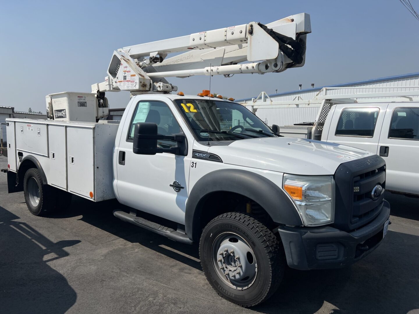 A white utility truck parked in the lot.