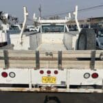 A white truck parked in the middle of a parking lot.