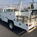 A white utility truck parked in the parking lot.