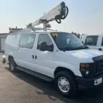 A white van with a crane on top of it.