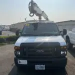 A white truck with a crane on the back of it.