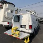 A van with a ladder on the back of it